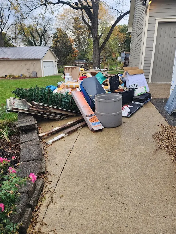 Dumpster being loaded with debris for Commercial Dumpster Rental in Swarthmore
